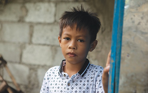 8-year-old John from the Philippines received sight-saving cataract surgery at a cbm-funded eye hospital.