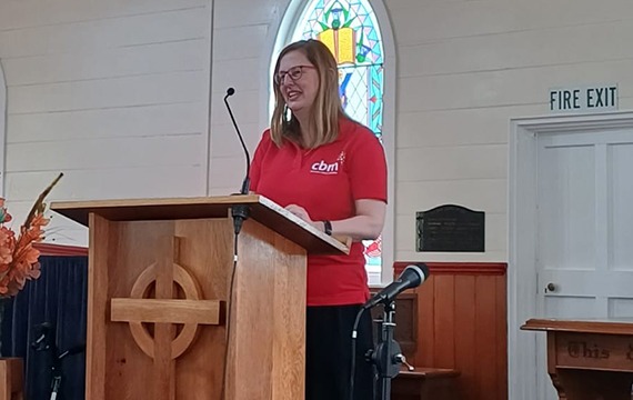 Judi from cbm's finance team talking at a church.