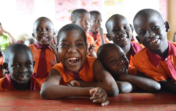 aboutus-ourvalues Sure Prospects Primary school is an inclusive school. It is a partner school with CoRSU hospital, CBM’s partner in Entebbe district in Uganda. Please refer to respective report. 
Here Shamilla a 12 year old girl with other pupils in the classroom. Shamilla has cerebral palsy and associates well with other children in this school.